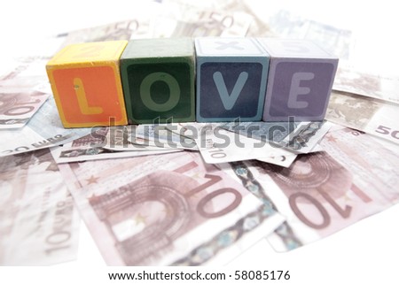 assorted childrens toy letter building blocks on money that spell love