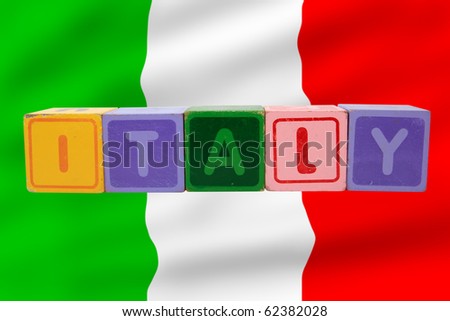 toy letters that spell italy against a flag background with clipping path