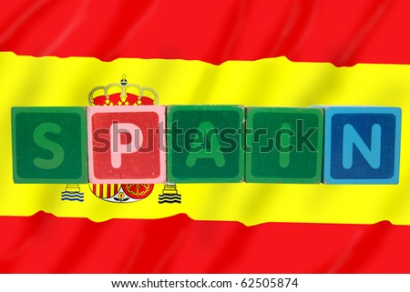 toy letters that spell spain against a flag background with clipping path