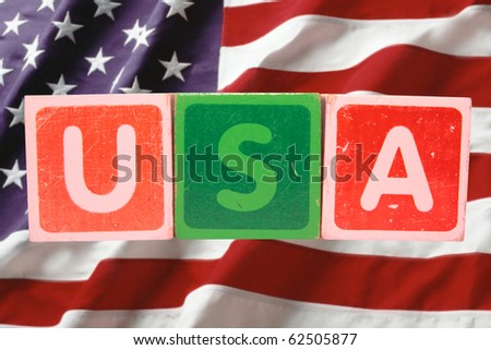 toy letters that spell usa against a flag background with clipping path