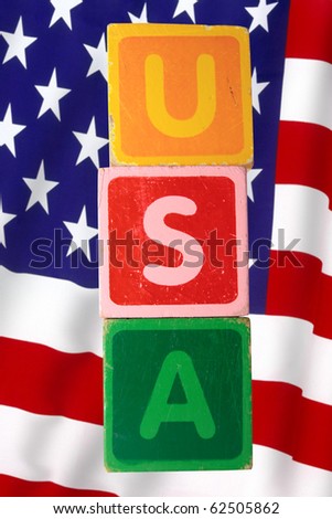 toy letters that spell usa against a flag background with clipping path
