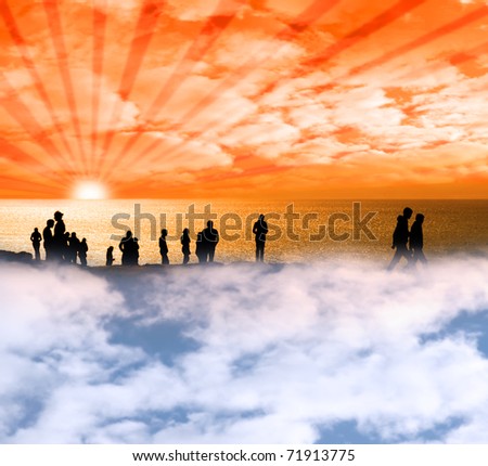 Silhouette of crowd of people on the edge of a cliff in ireland with there heads in the clouds
