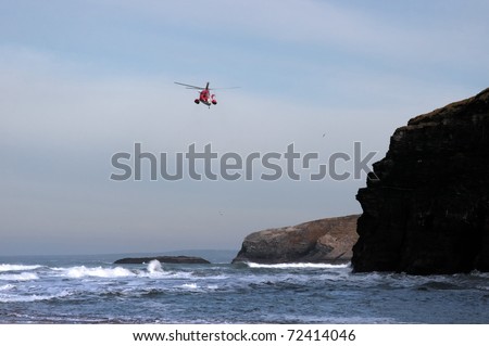 BALLYBUNION,IRELAND-MARCH 2:  Irish sea rescue helicopter searches for missing person near cliffs on March 2,2011 in Ballybunion, county Kerry, Ireland. The cliffs are often used in suicide attempts.