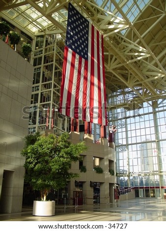 big hanging american national flag inside mobile city hall