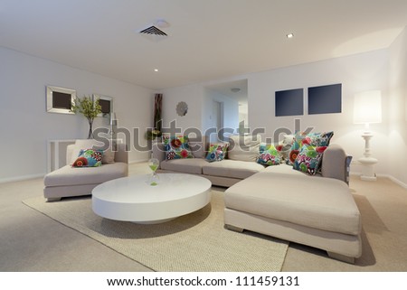 Modern living room with couch and round table in new Australian apartment