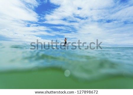 Stand up paddle boarder on open ocean