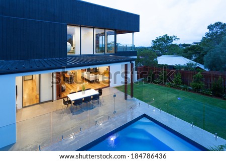 Luxury home with swimming pool at dusk