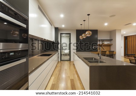 Modern minimalist kitchen and living room at night