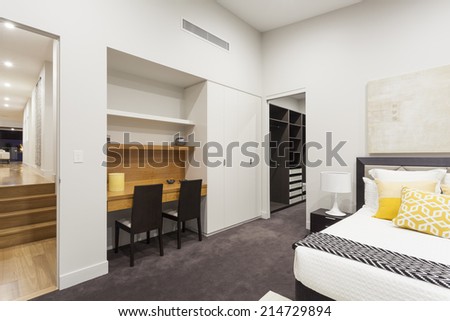 Modern bedroom with walk in robe and office desk