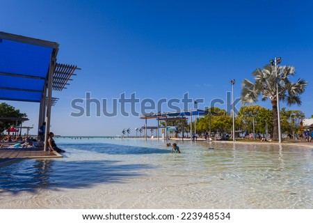 CAIRNS, QUEENSLAND/AUSTRALIA - OCTOBER 15: Tourists and locals enjoy the sunshine at the city centre lagoon pool on October the 15th, 2014 in Cairns.