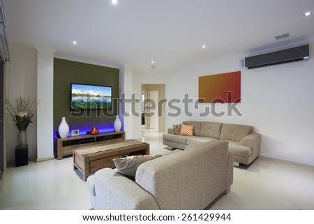 Stylish living area with flat screen TV and air conditioning