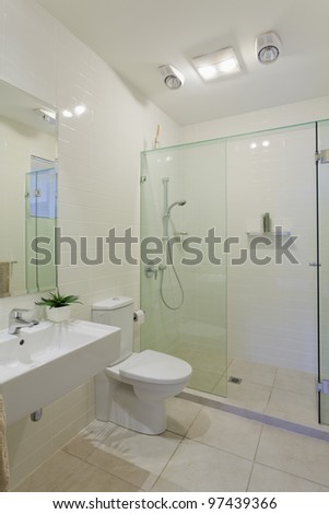 Stylish modern bathroom with shower, sink and toilet