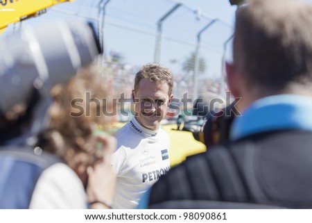 MELBOURNE, AUSTRALIA - MARCH 17: Michael Shumacher smiles to the fans after he runs wide and gets stuck in the gravel trap, at the Australian Grand Prix on March 17, 2012 in Melbourne, Australia