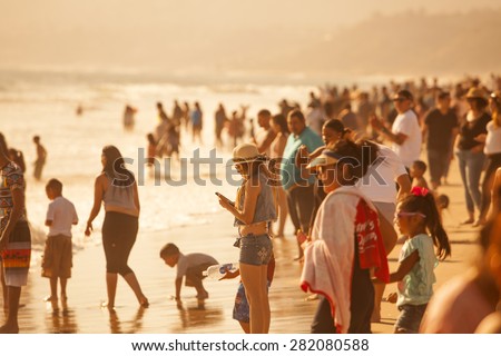 SANTA MONICA, CALIFORNIA/USA - MAY 24, 2015. Crowds gathered to sunbathe and swim at the Santa Monica State Beach near the Santa Monica Pier.