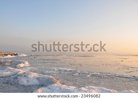 The ice of a lake is an icebound one under the blue sky in sunshine.