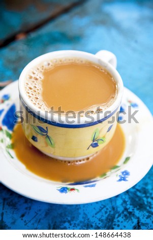 Burmese milk tea on blue wooden table