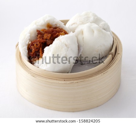 Delicious steamed buns in a bamboo steamer