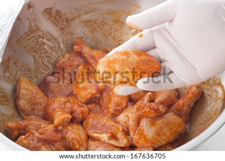 New orleans wings,Hand holding raw chicken wings in spice prepare for cooking