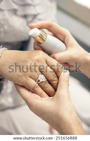 Hand of Old women testing skincare