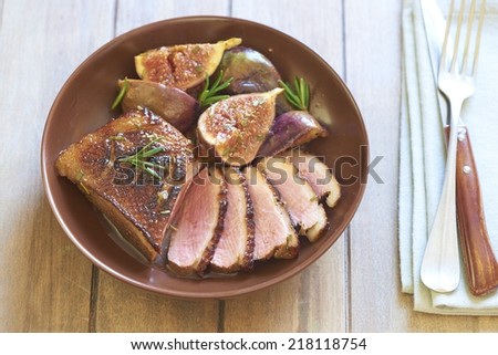 Roasted duck breast with figs and rosemary in wine sauce