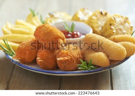 Fried cheese, vegetables and crab claws with tomato sauce