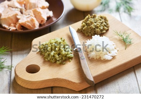 Lumaconi pasta with baked salmon, pickles and capers, italian cuisine. Cooking process. Step 3. Chopped ingredients