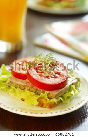 Sandwich with baked ham, lettuce and tomato