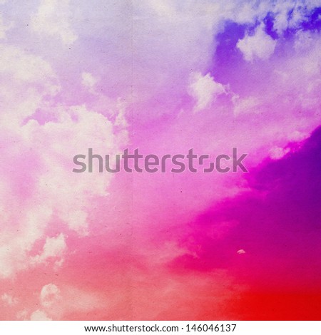 clouds on a textured vintage paper background, with grunge stains