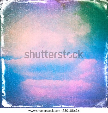 clouds on a textured vintage paper  background, with grunge stains