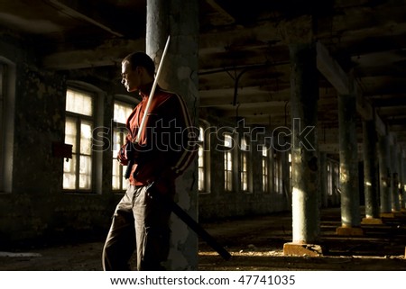 gangster with sword in industrial place