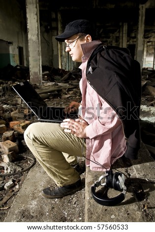 man with laptop in industrial place