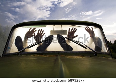 silhouettes of passengers in car full of smoke