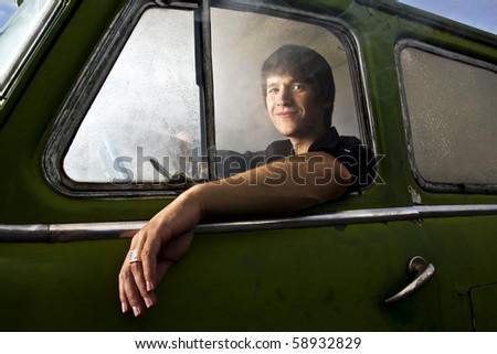 portrait of young man in the car full of smoke