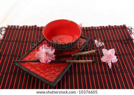 Chinese sticks, red plate and red cup