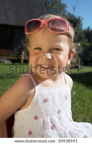 laughing  Cute girl with sunglasses on summer day