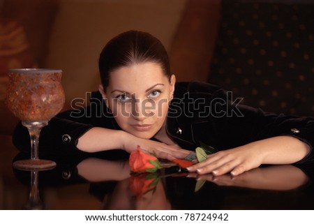 Portrait of an elegantly beautiful young woman posing on an antique sofa
