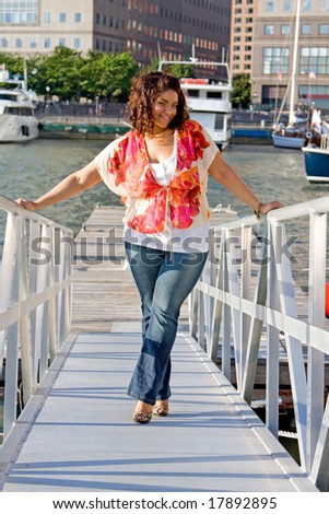 Beautiful plus size woman standing at a marina ramp