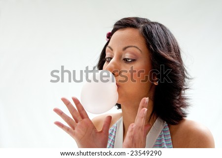 stock photo Beautiful Latina girl with crossed eyes blowing a bubblegum 