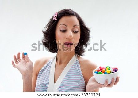  candy girl with a bowl of colorful bubblegum candy balls licking