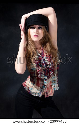 Beautiful cute country girl with long dirty-blond hair wearing a hat and arms around her head