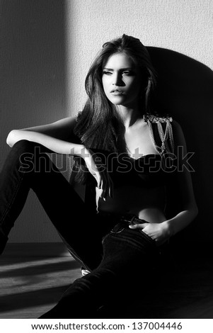 High fashion look. beautiful sexy stylish Caucasian young woman model sitting behind the window