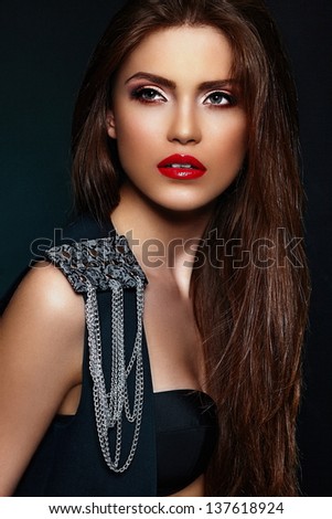 High fashion look.glamor closeup portrait of beautiful sexy stylish brunette Caucasian young woman model with bright makeup, with red lips,  with perfect clean skin with jewelery in black cloth