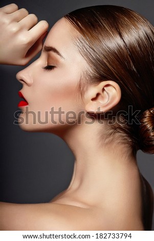 High fashion look.glamor closeup portrait of beautiful sexy stylish brunette Caucasian young woman model with bright makeup, with red lips,  with perfect clean skin in studio