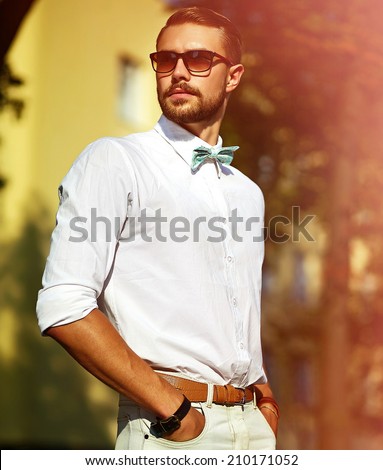 Young stylish sexy handsome model man in casual cloth lifestyle in the street in glasses