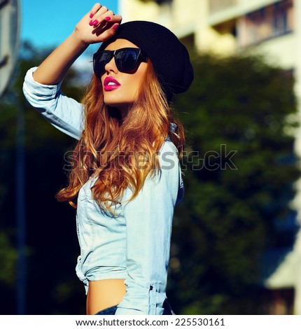 High fashion look.glamor lifestyle blond woman girl model in casual jeans shorts cloth outdoors in the street in black cap in glasses