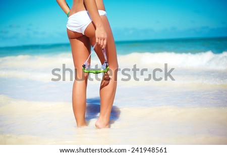 High fashion look. back of glamor sexy sunbathed model girl in white lingerie behind blue beach ocean water with water mask