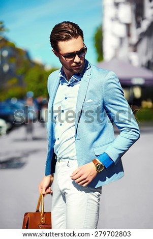 High fashion look.Young stylish confident happy handsome businessman model  in suit cloth lifestyle in the street in sunglasses