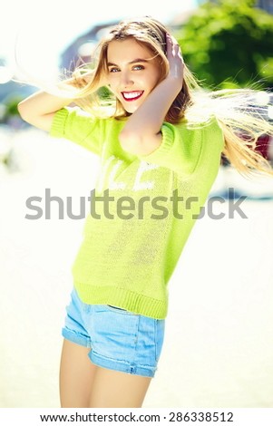 Funny  stylish sexy smiling beautiful young woman model in summer bright yellow   hipster cloth in the street