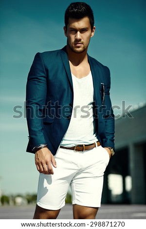 Fashion portrait of young sexy businessman handsome  model man in casual cloth suit in sunglasses in the street