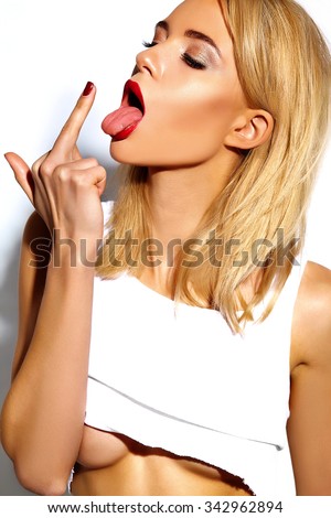 fashion glamor stylish swag young woman model with perfect sunbathed body with red lips show middle finger, fuck you off sign on white background